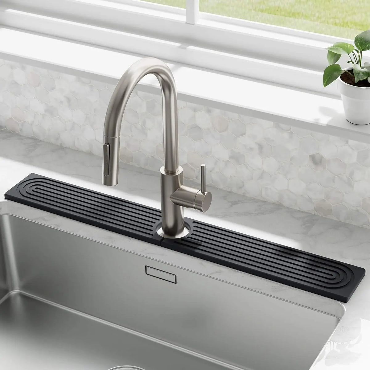A modern stainless steel faucet mounted on a black absorbent stone tray above a kitchen sink.