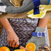 A hand wearing a stainless steel cut-resistant safety glove is holding a cleaned oyster shell.