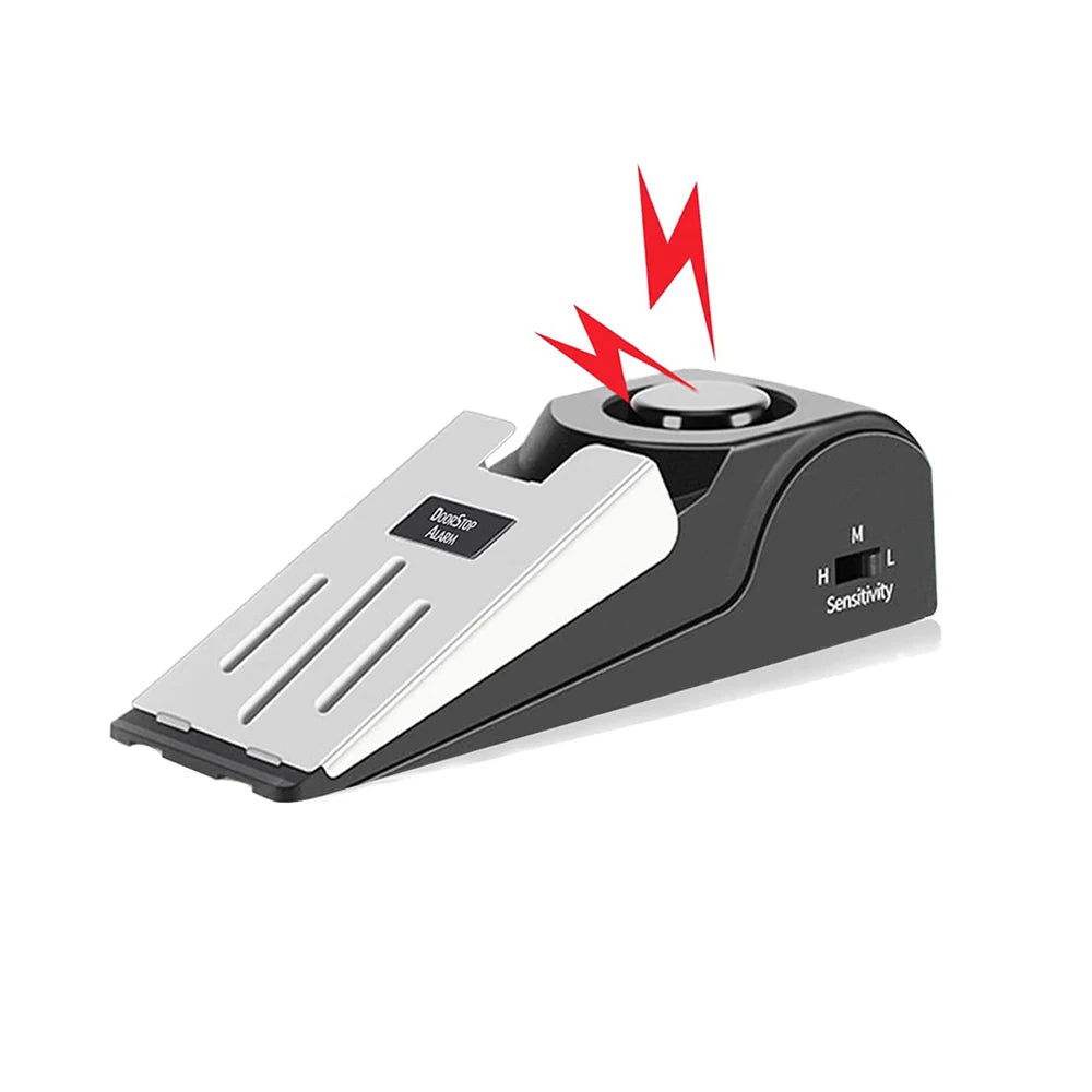 A black portable door stopper alarm with a wedge design and sensitivity settings, showing a lightning bolt symbol.