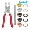 A set of metal eyelet and grommet pliers, including various sized rings and a long rod.