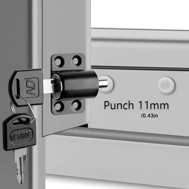Close-up of a sliding door lock mechanism with a punch and two keys installed on a silver frame.