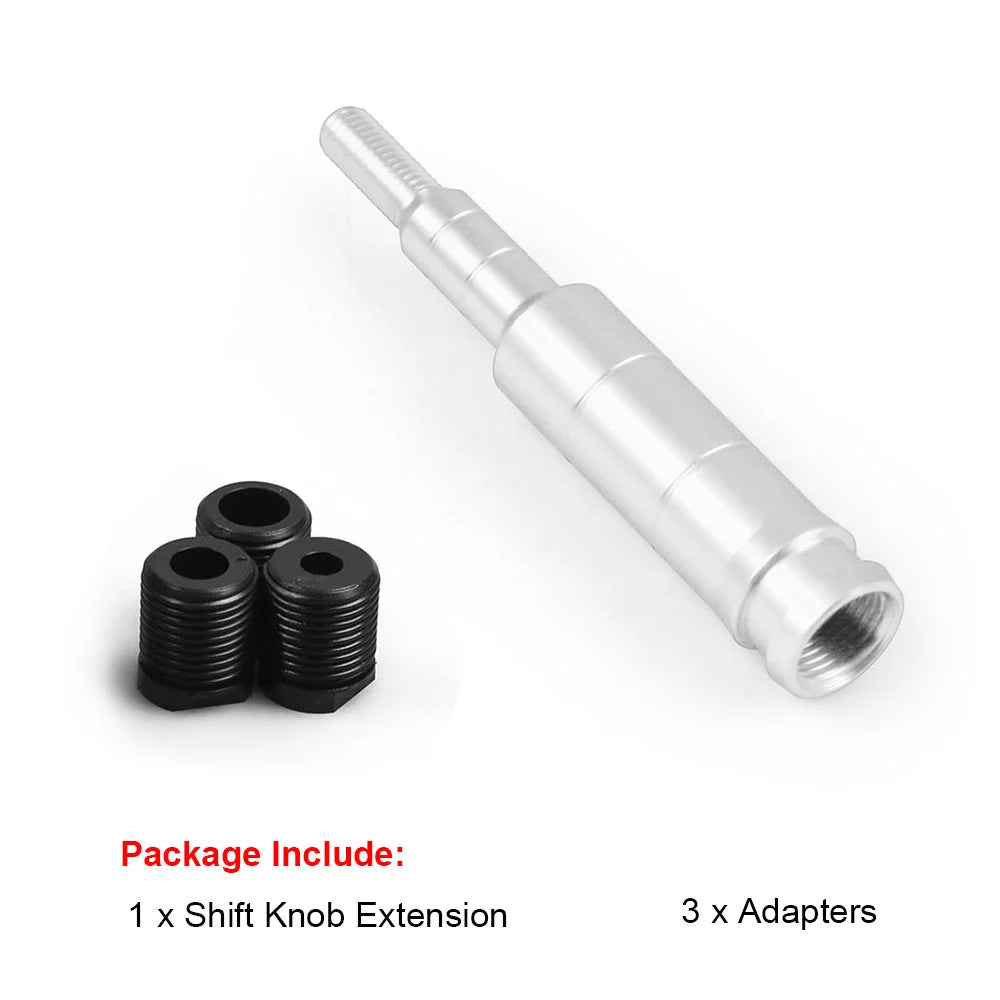 A silver aluminum shift knob extension and three black adapters for a vehicle