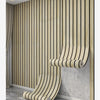 A vertical wall covered in light wood grain wallpaper featuring vertical stripes, with a rolled-up section visible.