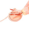 A hand holds a rose gold crystal rhinestone pacifier chain clip set with silicone nipple.