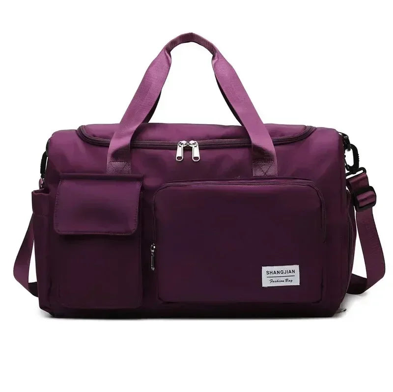 A deep purple large capacity travel duffel bag with a separate shoe compartment and carrying straps.
