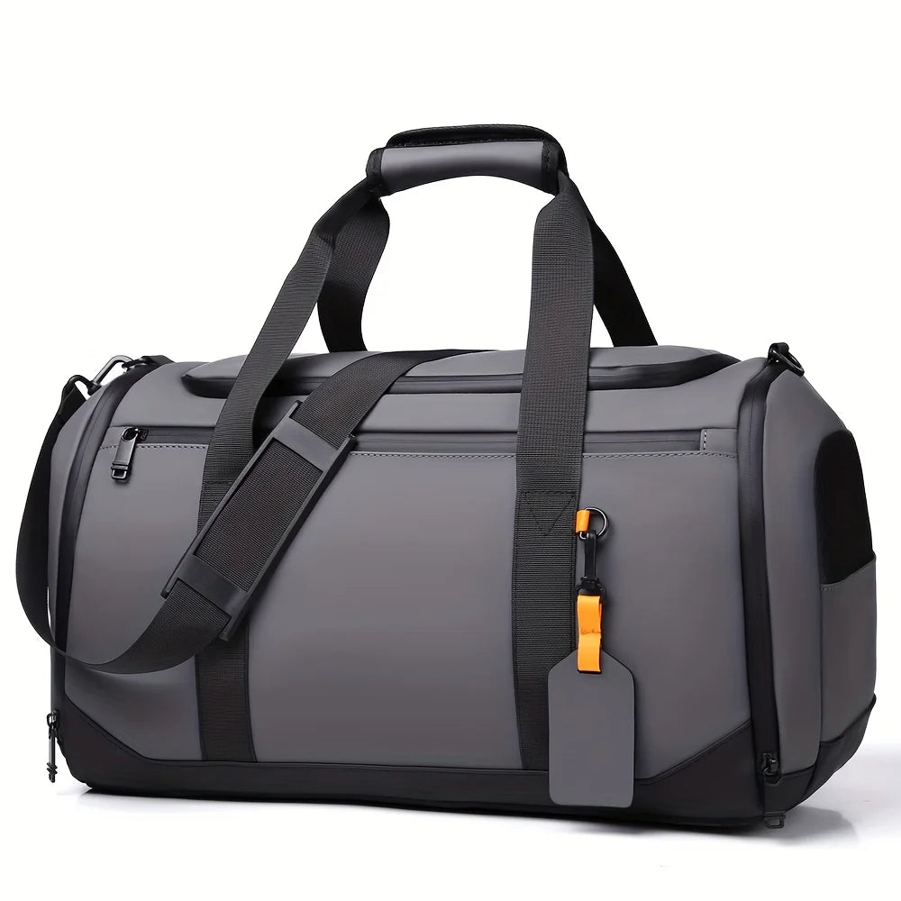 A gray large capacity travel duffel bag with black straps and an orange tag.