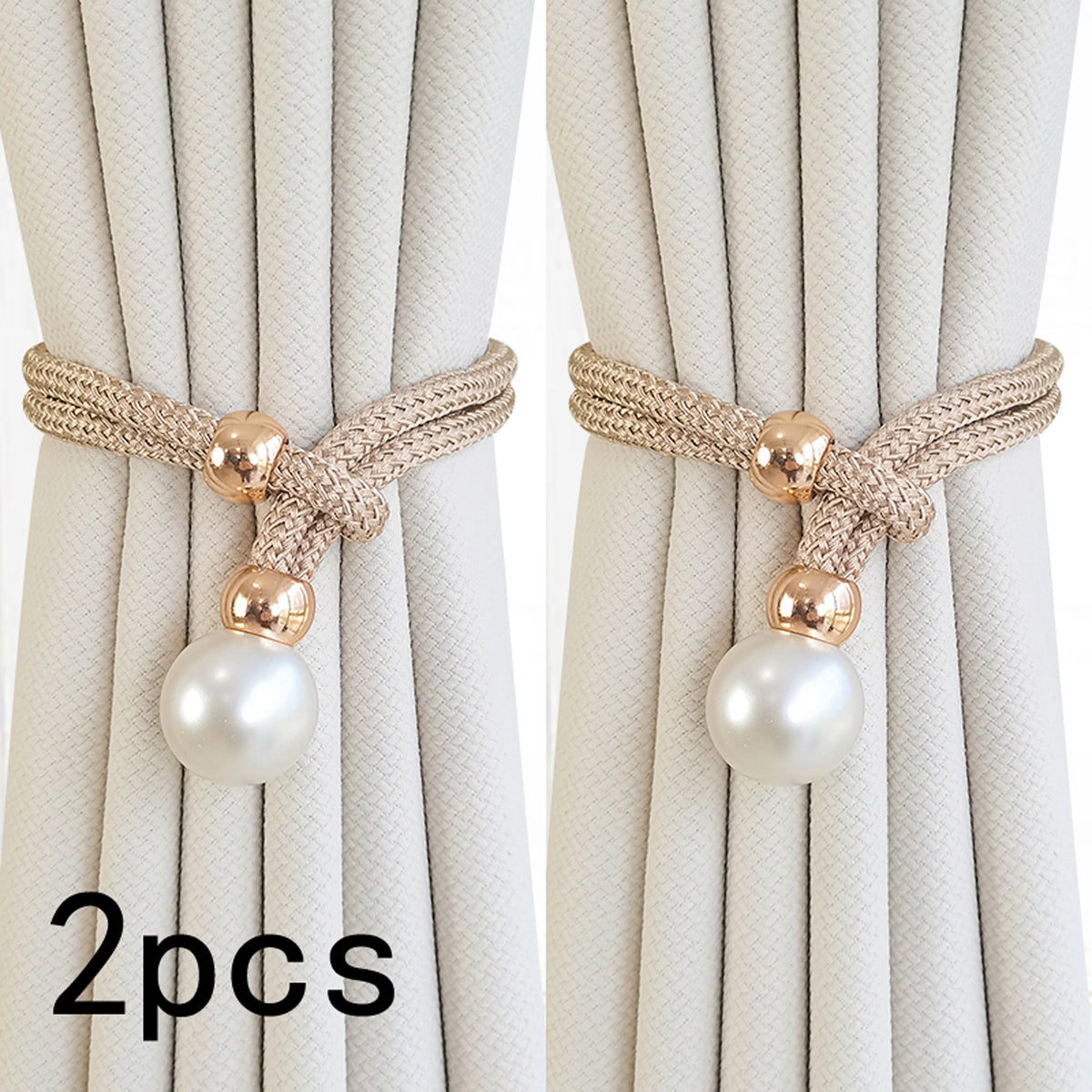 A set of two pearl and rope curtain tie-backs with gold accents shown against a light fabric background.