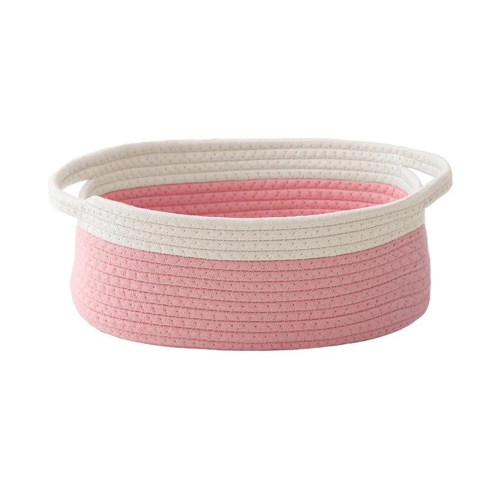 Handwoven rope storage basket in pink and cream with handles