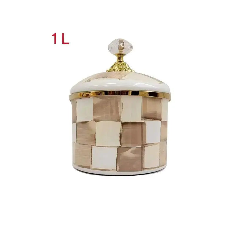 A cream and beige checkerboard porcelain storage jar with a gold lid.