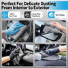 Hands wearing gloves are using a gray microfiber cloth to dust and clean the interior and exterior of a car.