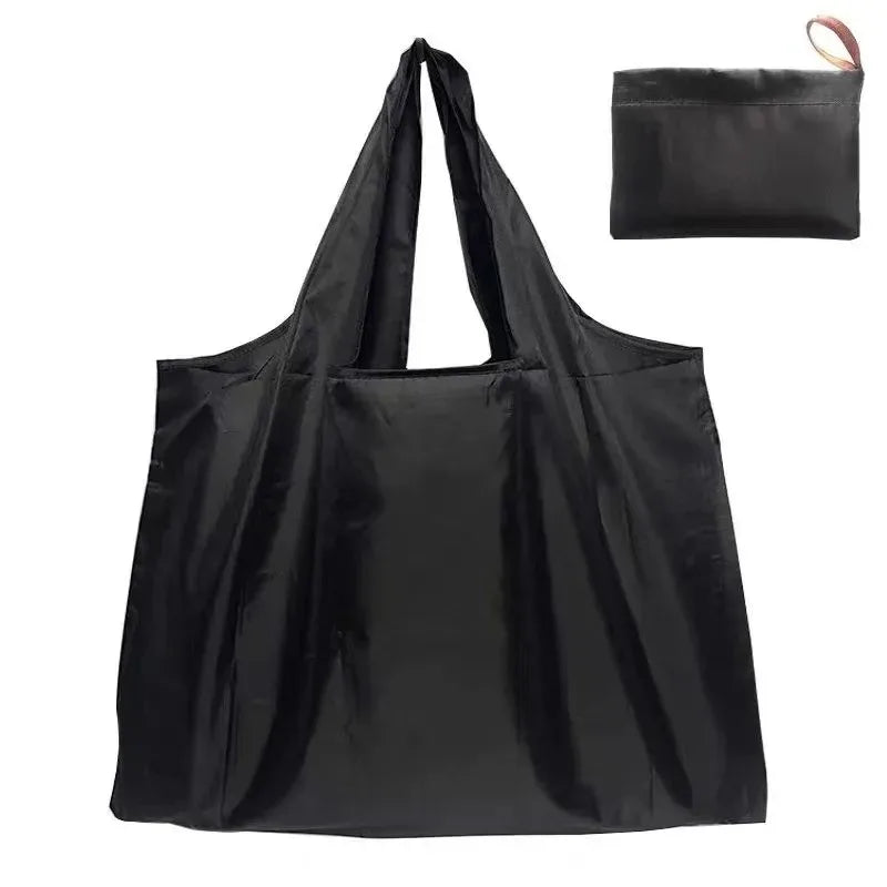 Black foldable nylon shopping tote bag with a handle and a separate pouch.