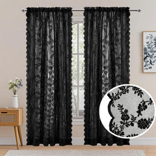 A pair of black vintage floral lace sheer curtains hanging in a window.