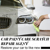 A hand is applying a yellow cleaning cloth to the headlight of a white car, demonstrating a car paint scratch repair agent.