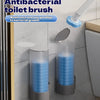 A wall-mounted disposable antibacterial toilet brush set with a blue handle and replaceable heads is shown on a bathroom wall