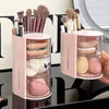 A pink clear acrylic organizer for hair accessories with rotating compartments and various brushes.