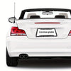 Rear view of a white car with an aluminum license plate frame and black and grey camo finish.