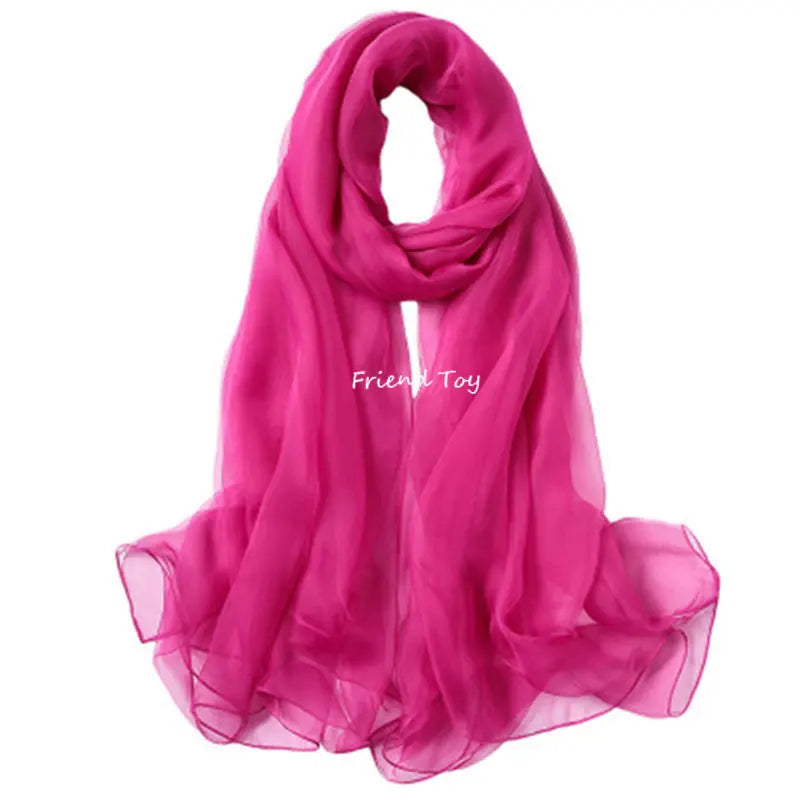 A vibrant pink silk scarf draped elegantly