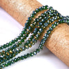 Green faceted crystal glass spacer beads strung on a brown cork for jewelry making