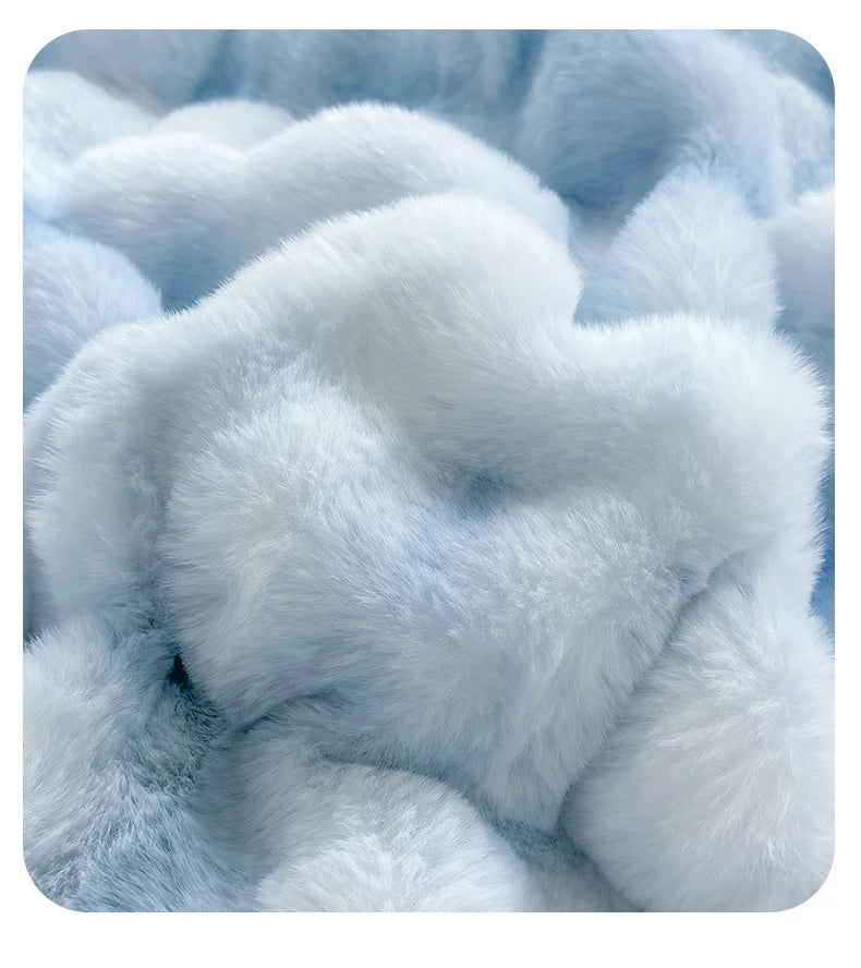 Close-up of a light blue fluffy fleece fabric with a rabbit design pattern.