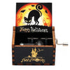 A wooden music box with a Halloween theme featuring a black cat silhouette against an orange moon background.