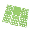 A set of green plastic folding boards used for organizing and folding clothes or t-shirts.