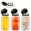 Three clear plastic juice bottles with black tamper-evident caps filled with yellow, red, and milky beverages.