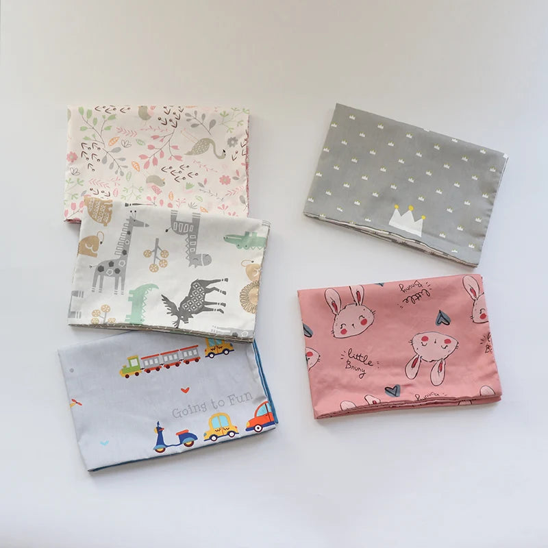 A collection of five soft cotton baby pillowcases featuring various cartoon designs and patterns.