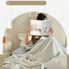 A striped breathable summer quilt is displayed on a bed, featuring a jacquard cotton cover.