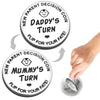 A double-sided decision coin showing Daddy's turn and Mummy's turn for new parents