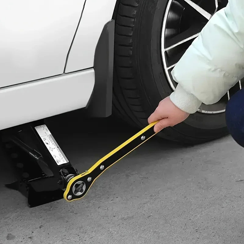 A hand is using a yellow labor-saving ratchet wrench on a tire near a white car.