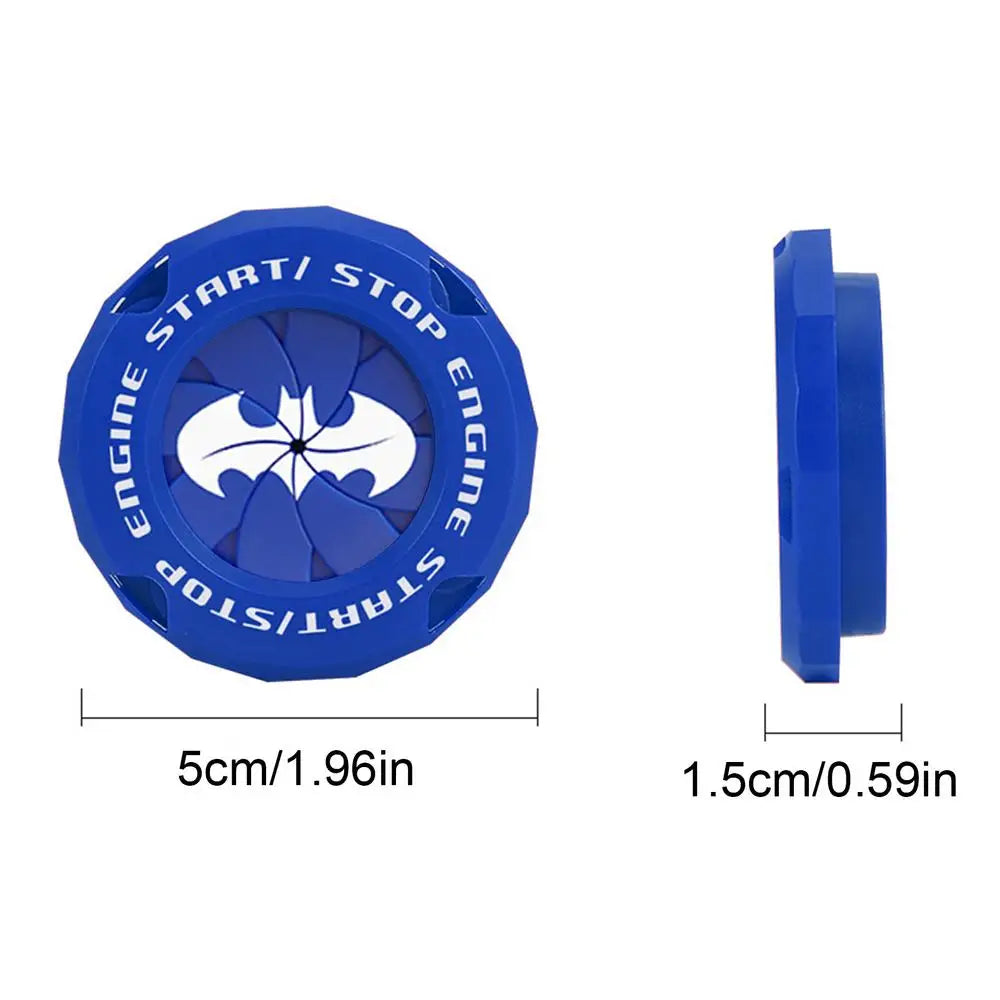 Blue push start button cover with a bat emblem and stop markings