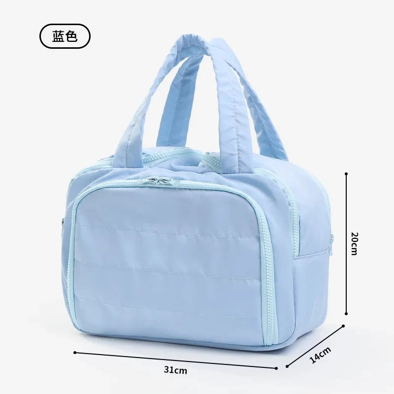 Light blue travel makeup bag with a wide opening shown from the front.