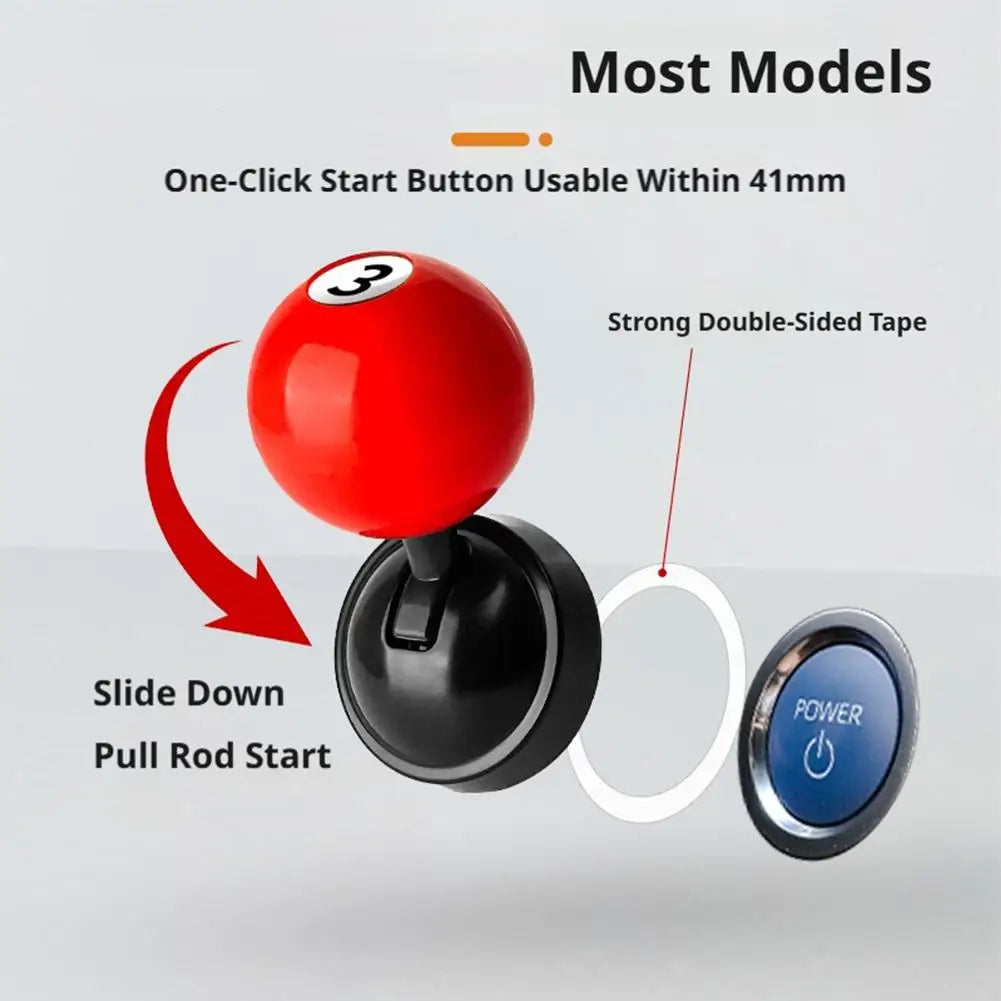 A red billiard ball shaped push-to-start button cover with a black base and a blue power switch visible.