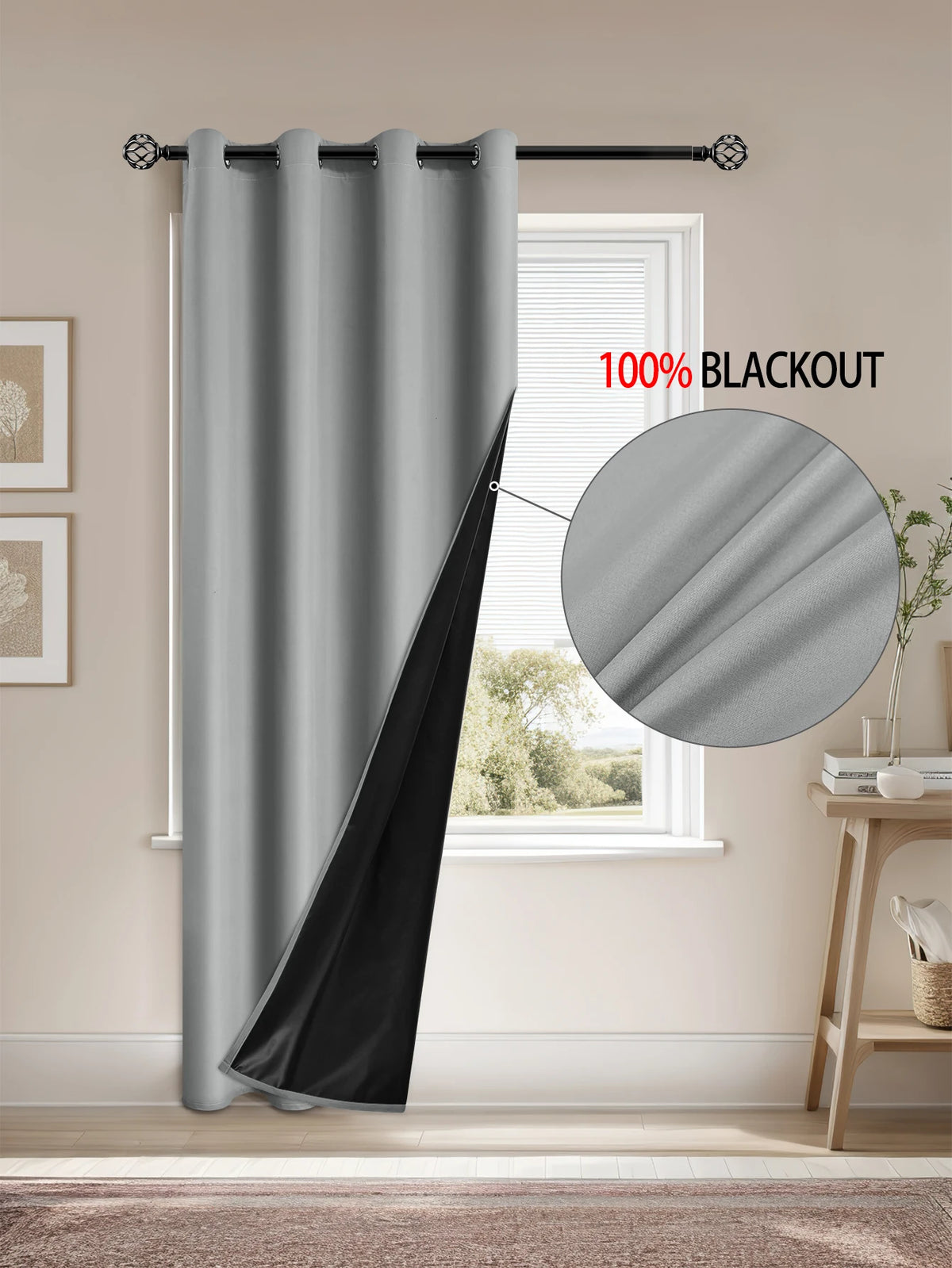 A gray blackout curtain hanging on a rod in a window, showing the fabric texture and black lining detail.