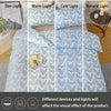 A set of heart print duvet cover and pillowcases in blue and gray fabric displayed under dim, warm, cold, and natural light.