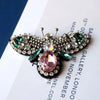 Handcrafted rhinestone bee sew-on patch featuring sparkling wings and a pink gemstone center