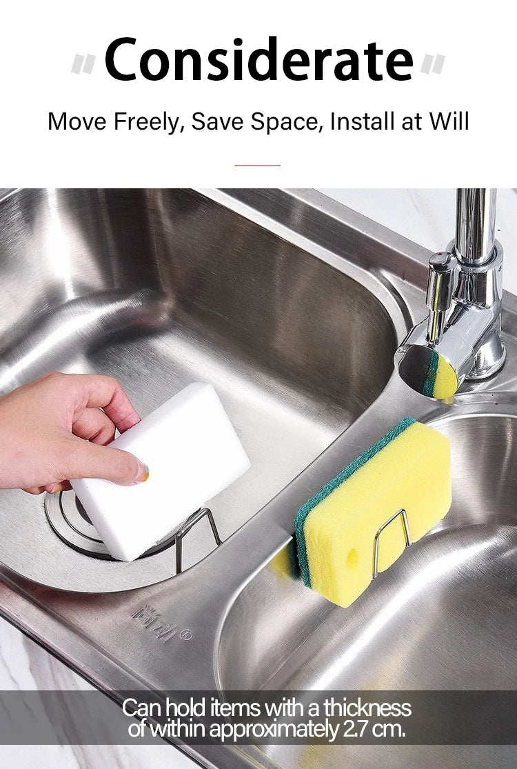 A hand is placing a white sponge into a stainless steel holder on a kitchen sink.