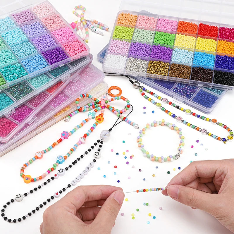 A hand is shown holding strings of multicolor acrylic rice beads and a storage box filled with similar beads.