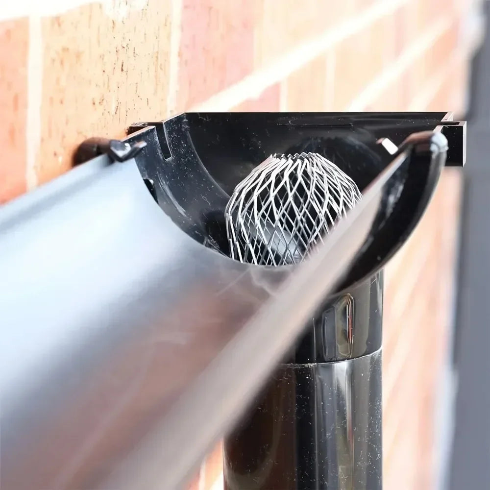 Close-up of an aluminum gutter leaf guard set being installed on a window frame.