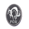 Black embroidered patch featuring a silver fox head design with lightning bolts and the word FOX.