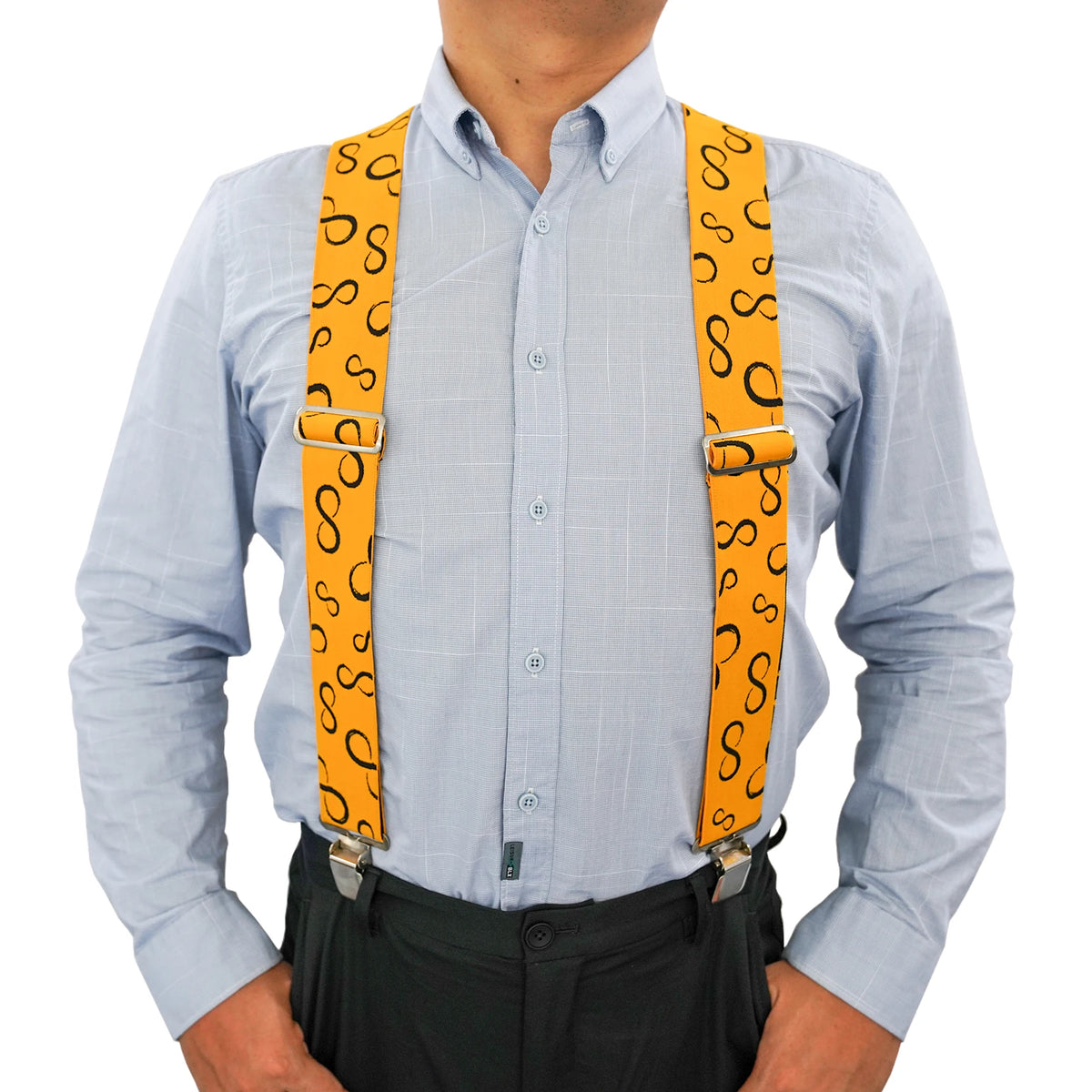 A man wearing a light blue shirt and black pants with bright orange elastic suspenders.