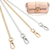 A collection of versatile metal chain straps and a pink quilted leather bag with gold hardware.