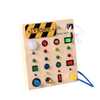 A wooden busy board with various buttons, lights, and switches for a Montessori sensory toy.