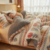 A person is relaxing on a bed covered with an ultra-soft anti-static plush throw blanket.
