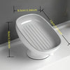 White bathroom soap rack with a drain tray and suction cup, shown in profile.