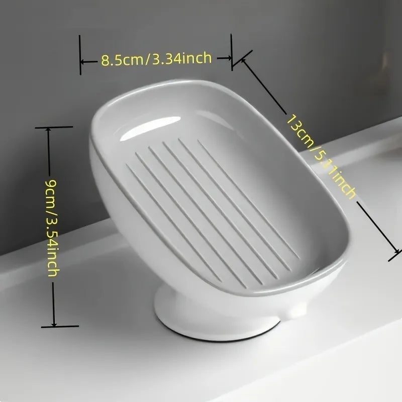 White bathroom soap rack with a drain tray and suction cup, shown in profile.