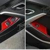 Close-up view of red interior and exterior trim components for a Chevrolet Camaro vehicle.