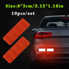 Ten reflective orange safety strips for car visibility shown next to a dark car body.