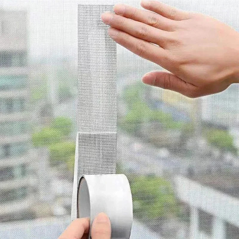 A hand is shown applying self-adhesive fiberglass screen repair tape to a window or screen surface.
