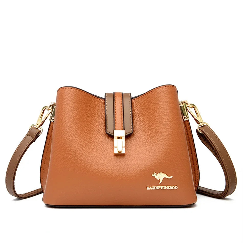 A brown leather shoulder bag with a gold-toned clasp and strap is shown against a white background.
